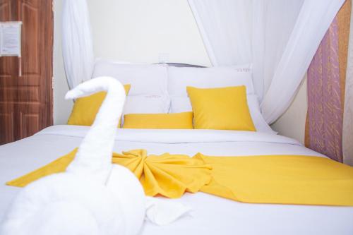 a bed with two swans sitting on top of it at Happy Springs Hotel & Accomodation in Kericho