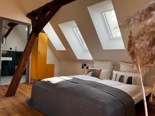 a bedroom with a bed and two skylights at Das Timmann in Stelle