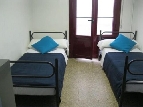 A bed or beds in a room at Ideal Youth Hostel