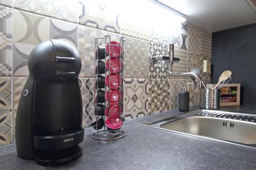 a hair dryer sitting on a counter next to a sink at City Hall view Apartment Liberec in Liberec