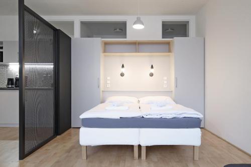 a bedroom with a white bed in a room at City Hall view Apartment Liberec in Liberec