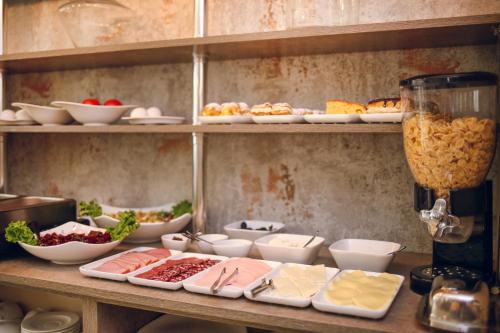 a counter with a bunch of different types of food at Hotel Kera in Tbilisi City