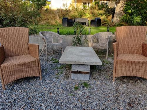 a group of chairs and a table in a yard at House. 80m2, near Lake, with car charge. in Sommarbo