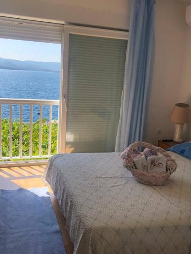 a bedroom with a bed with a view of the ocean at Apartment Bonaca in Komarna