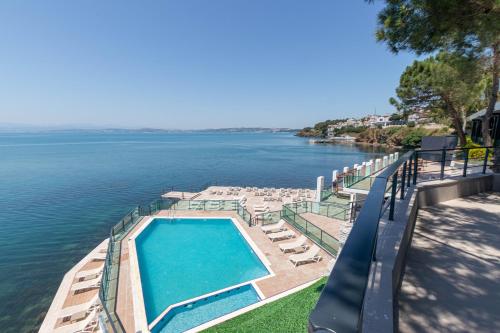 a swimming pool next to a body of water at Vira Otel Suites in Sinop
