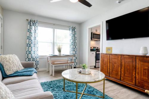 a living room with a couch and a tv at 2BR 1BA Duplex House King Beds Great for Small Groups Close to All Uptown Charlotte attractions in Charlotte