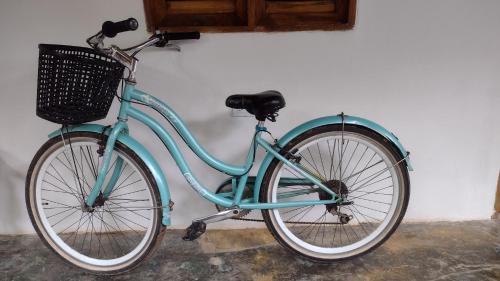 a blue bike is parked against a wall at Cabaña Buenos Aires in Palomino