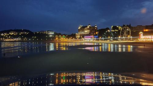 a city lit up at night with a river at St Michael's Guest House in Scarborough