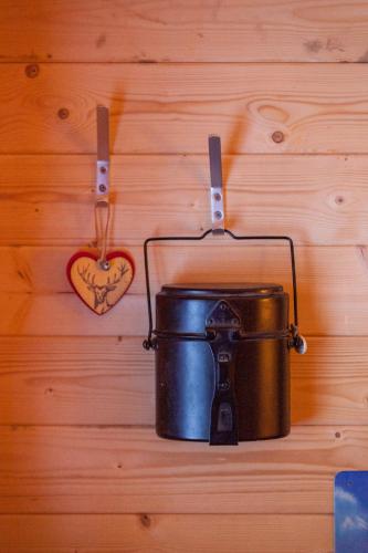 a pot and a heart hanging on a wall at Hotel Jägerhof in Zermatt