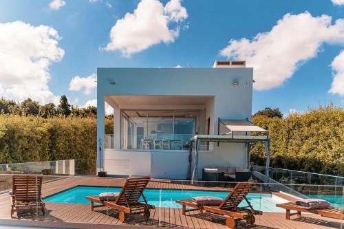 a villa with a swimming pool and a house at Quinta do Charco in Ribeira Grande