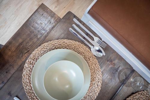 a table with a white plate and fork and knife at Lancefield House - Spacious 5 Bedroom - Sleeps 15 in Walton on the Hill