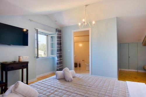 a bedroom with a large bed and a bathroom at History House in Corfu Town
