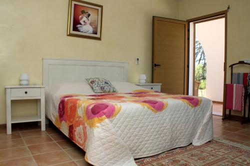 a bedroom with a bed and a door to a patio at Casa Mia in Ouled Kacem