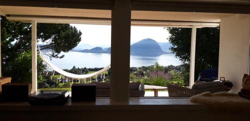 a room with a large window with a view of the water at Relaxing place on Godøya in Godøy