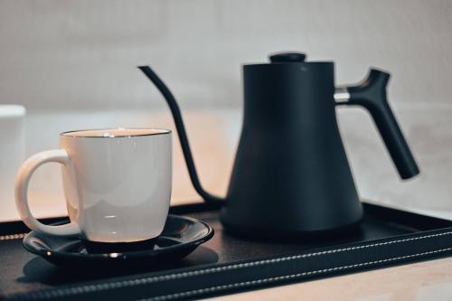a coffee pot and a cup on a tray at Cannery Pier Hotel & Spa in Astoria, Oregon
