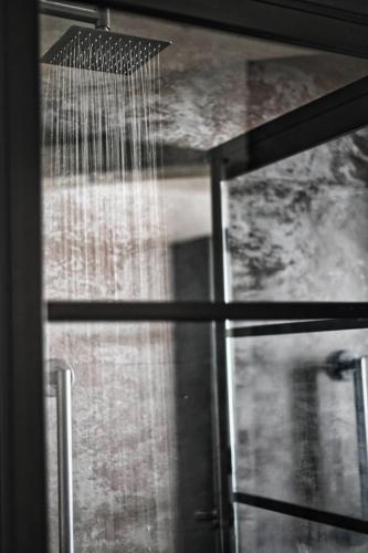 a window with a shower with water pouring out at Cannery Pier Hotel & Spa in Astoria, Oregon