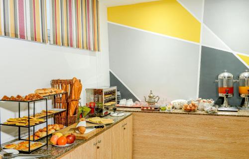 a buffet line with various types of bread and pastries at Manzil Hotel in Casablanca