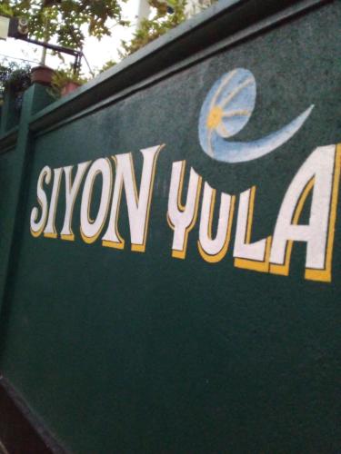 a sign for a snow julilla on a wall at Siyon Yula - Guest House in Hikkaduwa
