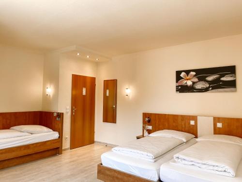 two beds in a room with two beds sidx sidx sidx at Hotel Falk in Bremen