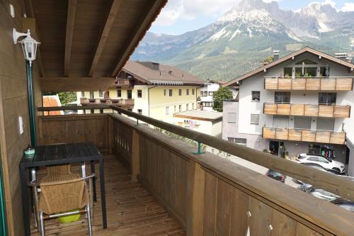 a balcony with a table and a view of a mountain at Appartement Ingrid in Ellmau