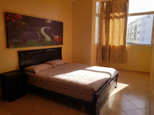 a bedroom with a bed and a window at Dar Sara in Asilah