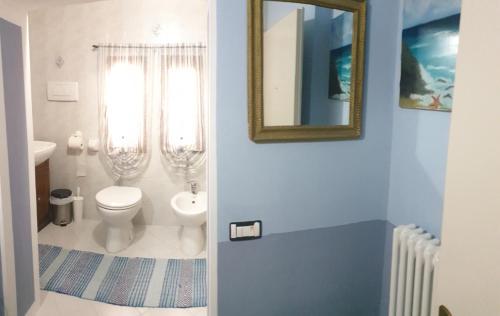 a bathroom with a toilet and a mirror at B&B Villa Giardini Susanna in Gattico