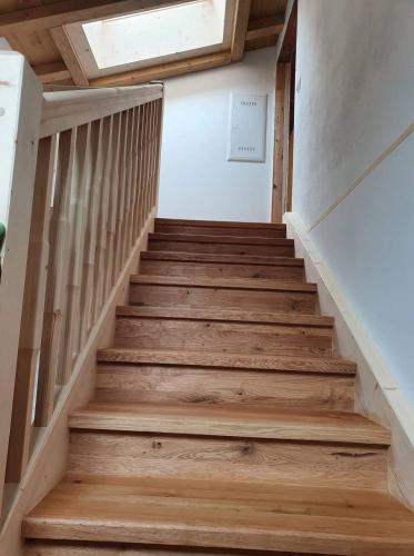 a staircase in a house with wooden floors and a window at Appartement Ingrid in Ellmau
