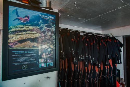 a bunch of black shirts hanging on a rack at Sangat Island Dive Resort in Coron