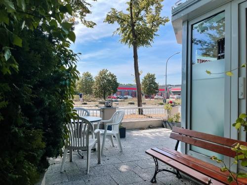 a patio with a table and chairs next to a building at Hotel Falk in Bremen