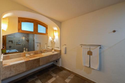 a bathroom with a sink and a mirror at Casa De Sierra Azul in Oaxaca City