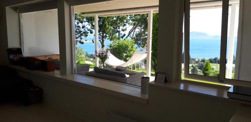 a room with a window with a view of the ocean at Relaxing place on Godøya in Godøy