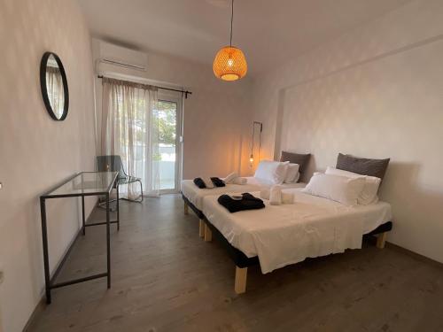 a bedroom with two beds and a glass table at MV central in Rhodes Town