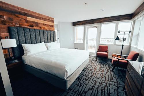 a hotel room with a bed and a chair at Cannery Pier Hotel & Spa in Astoria, Oregon