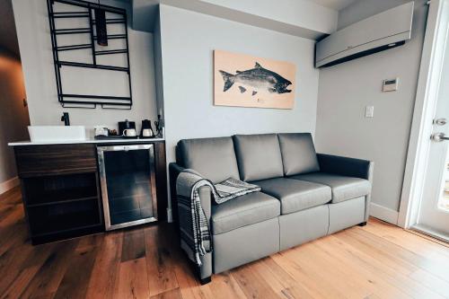 a living room with a couch and a fireplace at Cannery Pier Hotel & Spa in Astoria, Oregon