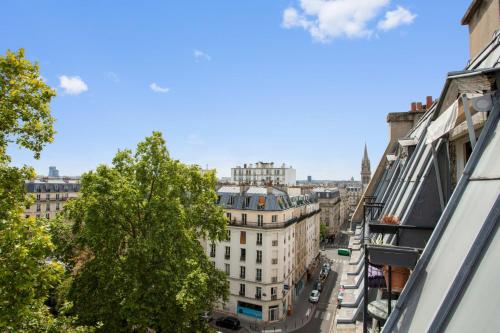 a view of a city street from a building at Nice studio w balcony on Square Gardette in Paris - Welkeys in Paris