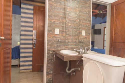 a bathroom with a sink and a toilet at Hotel Nuevo Suizo in San Juan