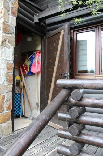 a group of logs sitting on a deck next to a door at Apartment Bajta - Rogla in Zreče