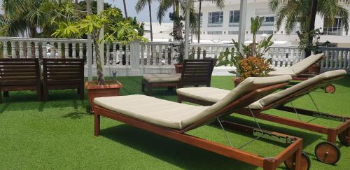 a couple of beds sitting on the grass at Villa las Flores in Adeje