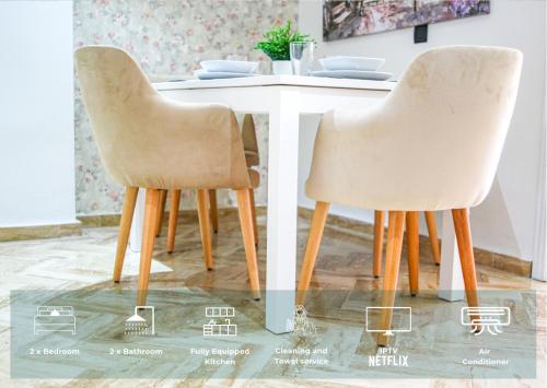 two chairs sitting at a table in a room at YourPlace Rabat Agdal 1 - Cozy Residence in Rabat