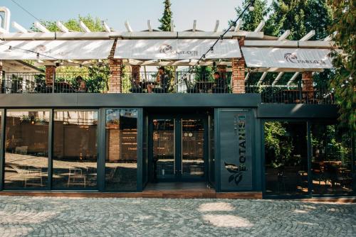 a restaurant with glass doors and a balcony at Sundial Boutique Hotel in Zagreb