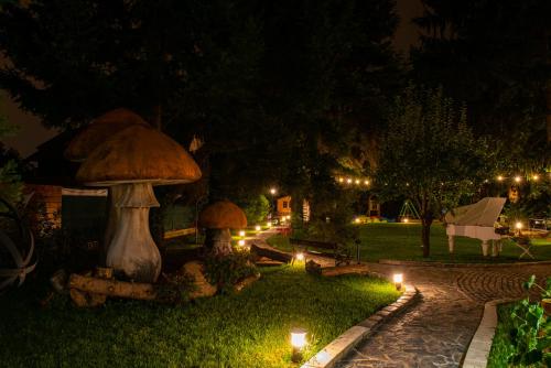 a garden with two mushrooms and lights at night at Sundial Boutique Hotel in Zagreb