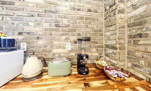 a kitchen counter with a blender on a brick wall at Masan First Class Hotel in Changwon