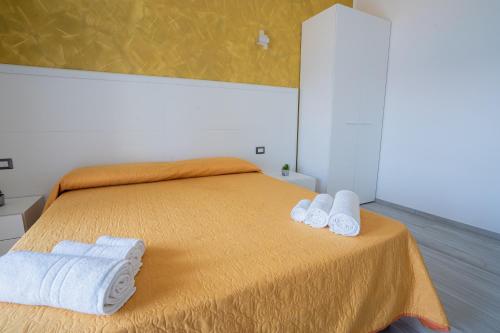 a bedroom with a bed with two towels on it at Harmonia Home Capitello in Capitello