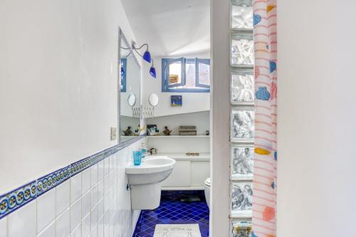 a bathroom with a white toilet and a sink at Maggiore 145 apartment with private garden - Rione Monti in Rome