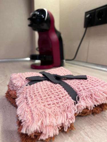 a black cat sitting on top of a pink blanket at Dalv Residence - SPA Fairy Tale in old Sofia in Sofia