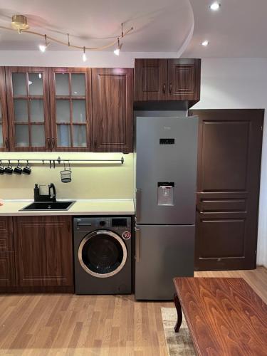 a kitchen with a washing machine and a sink at Dalv Residence - SPA Fairy Tale in old Sofia in Sofia