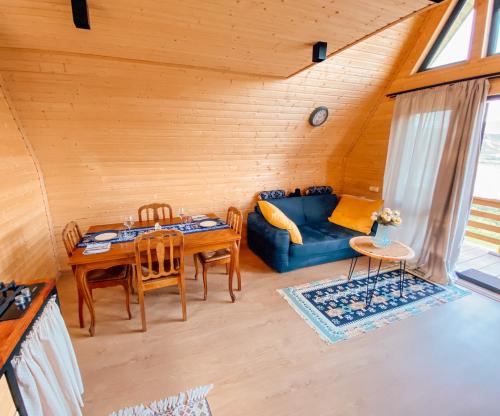 La Baita - ლა ბაიტა 2 في تبليسي: غرفة معيشة مع أريكة زرقاء وطاولة