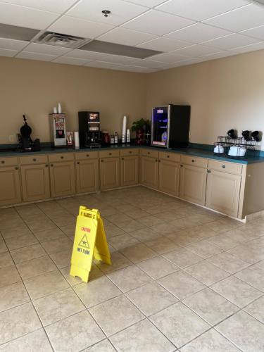 a yellow sign sitting on the floor in a kitchen at COLLINS INN & SUITES in Collins
