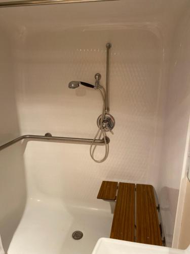 a bathroom with a bath tub with a shower at COLLINS INN & SUITES in Collins