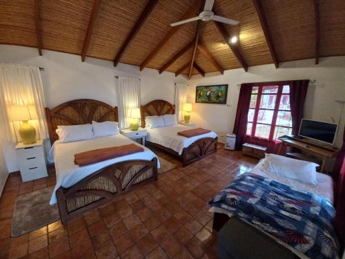 a bedroom with two beds and a television in it at Bungalows Sanlaz in Barrio Jesús